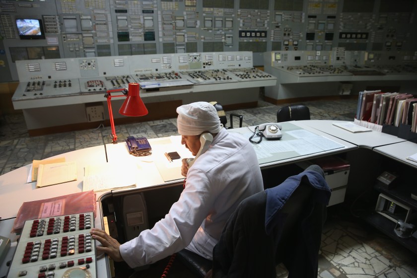 CHORNOBYL, UKRAINE - SEPTEMBER 29: A worker makes a phone call in the control room of reactor number two inside the former Chernobyl nuclear power plant on September 29, 2015 near Chornobyl, Ukraine. The Chernobyl plant is currently undergoing a decades-long decommissioning process of reactors one, two and three, which continued operation for years following the accident at reactor four. On April 26, 1986, technicians at Chernobyl conducting a test inadvertently caused reactor number four, which contained over 200 tons of uranium, to explode, flipping the 1,200 ton lid of the reactor into the air and sending plumes of highly radioactive particles and debris into the atmosphere in a deadly cloud that reached as far as western Europe. 32 people, many of them firemen sent to extinguish the blaze, died within days of the accident, and estimates vary from 4,000 to 200,000 deaths since then that can be attributed to illnesses resulting from Chernobyl's radioactive contamination. Today large portions of the inner and outer Chernobyl Exclusion Zone that together cover 2,600 square kilometers remain contaminated. A consortium of western companies is building a movable enclosure called the New Safe Confinement that will cover the reactor remains and its fragile sarcophagus in order to prevent further contamination. (Photo by Sean Gallup/Getty Images)