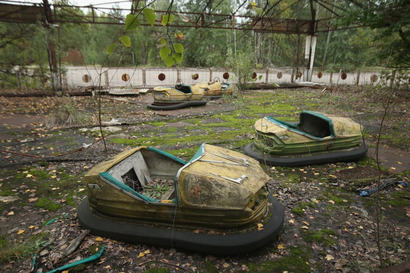 PRIPYAT, UKRAINE - SEPTEMBER 29: Bumper cars stand in an abandoned amusement park on September 29, 2015 in Pripyat, Ukraine. Pripyat lies only a few kilometers from the former Chernobyl nuclear power plant and was built in the 1970s to house the plant's workers and their families. On April 26, 1986, technicians at Chernobyl conducting a test inadvertently caused reactor number four to explode, sending plumes of highly radioactive particles and debris into the atmosphere. Authorities evacuated 120,000 people from the area, including 43,000 from Pripyat. Today Pripyat is a ghost-town, its apartment buildings, shops, restaurants, hospital, schools, cultural center and sports facilities derelict and its streets overgrown with trees. The city lies in the inner exclusion zone around Chernobyl where hot spots of persistently high levels of radiation make the area uninhabitable for thousands of years to come. (Photo by Sean Gallup/Getty Images)