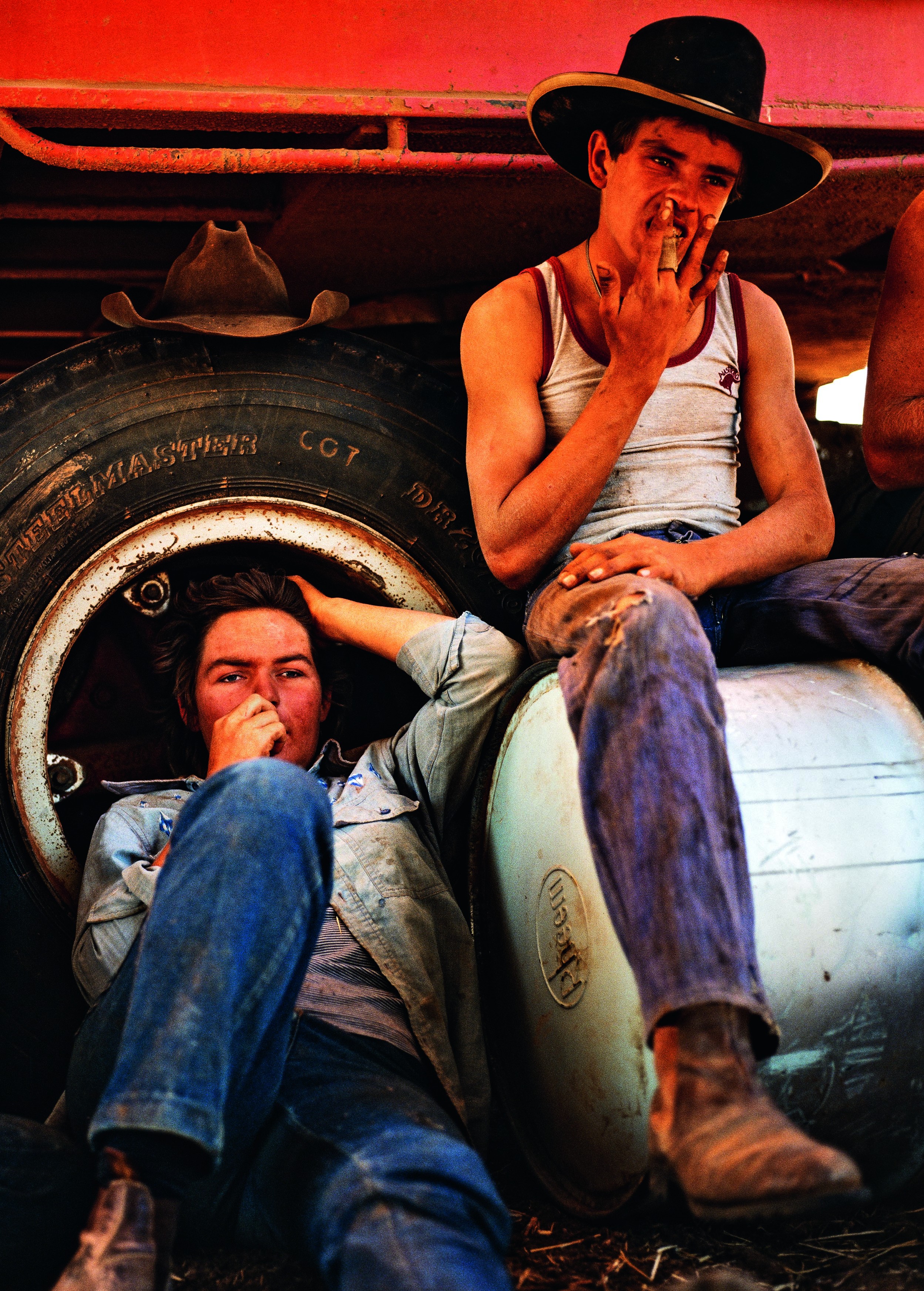 Resting in the shade of a tarpaulin. Jackaroo Malcolm Chillmon, 20, from Chippendale, New South Wales with Jillaroo Susan Gilmore from Brisbane, Queensland, and stationhand Mark Ashlin from Gulgung, New South Wales. (Balls and Bulldust by Hakan Ludwigson, publishd by Steidl)