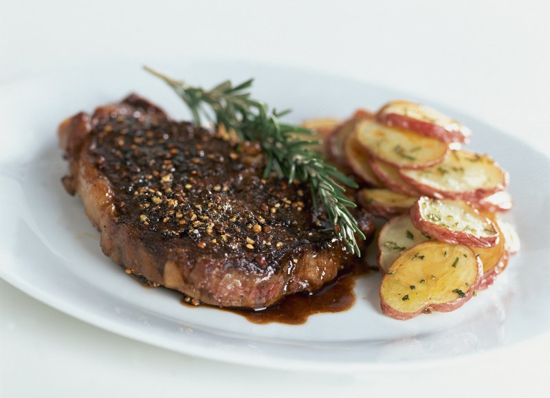 Rib-eye steak au poivre with balsamic reduction. Recipe by Lori W. Powell. (Photo by Romulo Yanes/Condé Nast via Getty Images)