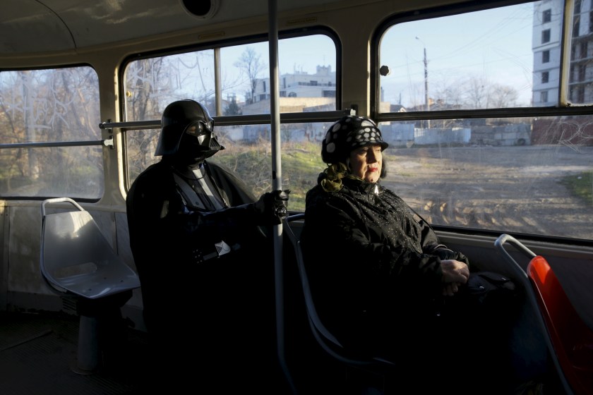 Darth Mykolaiovych Vader, who is dressed as the Star Wars character Darth Vader, poses for a picture as he rides on a tram in Odessa, Ukraine, December 3, 2015. Darth Vader was bent on galactic domination, but his Ukrainian namesake enjoys more mundane pursuits: local politics, walking the family dog and a spot of embroidery. The Ukrainian citizen, who has changed his name to Darth Mykolaiovych Vader, ran for the post of local mayor in October, his political backers dressed as Stormtroopers. In his trademark black outfit, he is a regular sight around Odessa, a major port city on southern Ukraine's Black Sea coast. REUTERS/Valentyn Ogirenko PICTURE 4 OF 22 - SEARCH "VALENTYN VADER" FOR ALL IMAGES - RTX1Y7XW