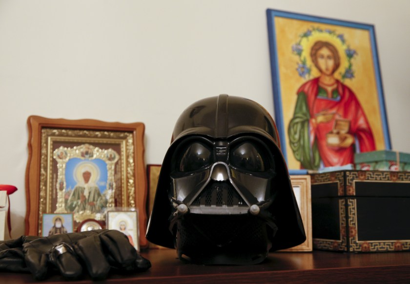 Darth Mykolaiovych Vader's Darth Vader helmet sits on a shelf among icons at his apartments in Odessa, December 2, 2015. Darth Vader was bent on galactic domination, but his Ukrainian namesake enjoys more mundane pursuits: local politics, walking the family dog and a spot of embroidery. The Ukrainian citizen, who has changed his name to Darth Mykolaiovych Vader, ran for the post of local mayor in October, his political backers dressed as Stormtroopers. In his trademark black outfit, he is a regular sight around Odessa, a major port city on southern Ukraine's Black Sea coast. REUTERS/Valentyn Ogirenko PICTURE 22 OF 22 - SEARCH "VALENTYN VADER" FOR ALL IMAGES - RTX1Y83J