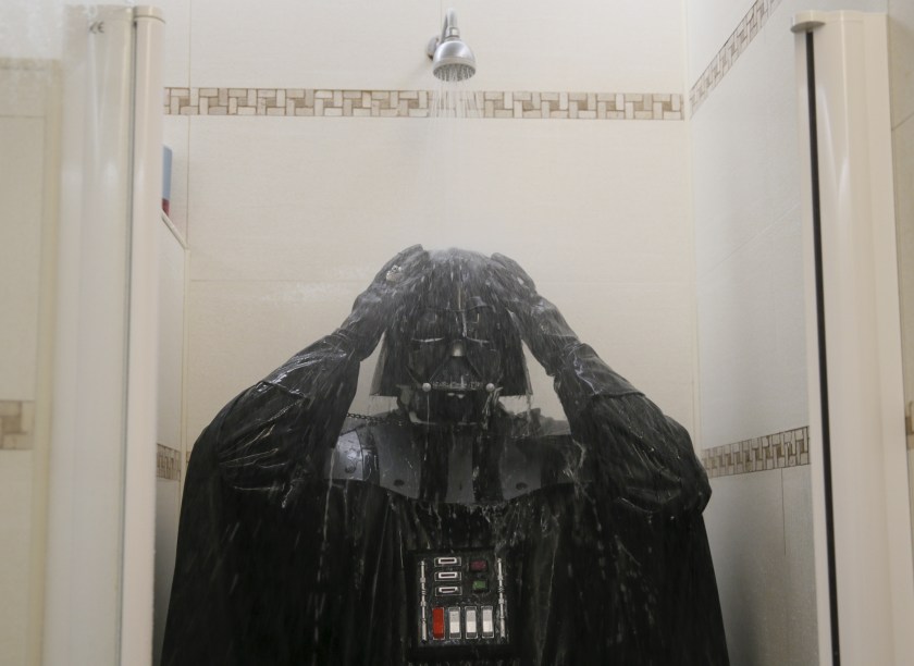 Darth Mykolaiovych Vader, who is dressed as the 'Star Wars' character Darth Vader, poses for a picture as he takes a shower in a bathroom at his apartments in Odessa, Ukraine, December 4, 2015. Darth Vader was bent on galactic domination, but his Ukrainian namesake enjoys more mundane pursuits: local politics, walking the family dog and a spot of embroidery. The Ukrainian citizen, who has changed his name to Darth Mykolaiovych Vader, ran for the post of local mayor in October, his political backers dressed as Stormtroopers. In his trademark black outfit, he is a regular sight around Odessa, a major port city on southern Ukraine's Black Sea coast. REUTERS/Valentyn Ogirenko PICTURE 18 OF 22 - SEARCH "VALENTYN VADER" FOR ALL IMAGES - RTX1Y83X