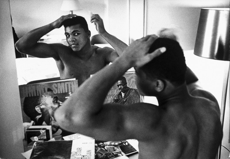 January 24, 1963 - Pittsburgh: Boxing heavyweight contender Cassius Clay (now Muhammad Ali) combing hair in mirror in hotel room before going outside on day of bout with opponent Charlie Powell. (Photo by Marvin Lichtner/The LIFE Images Collection/Getty Images)