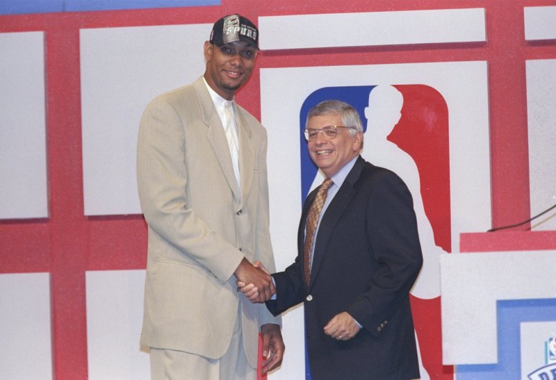 25 Jun 1997: Center Tim Duncan of the San Antonio Spurs shakes hands with NBA Commissioner David Stern during the NBA Draft at the Charlotte Coliseum in Charlotte, North Carolina. Mandatory Credit: Craig Jones /Allsport