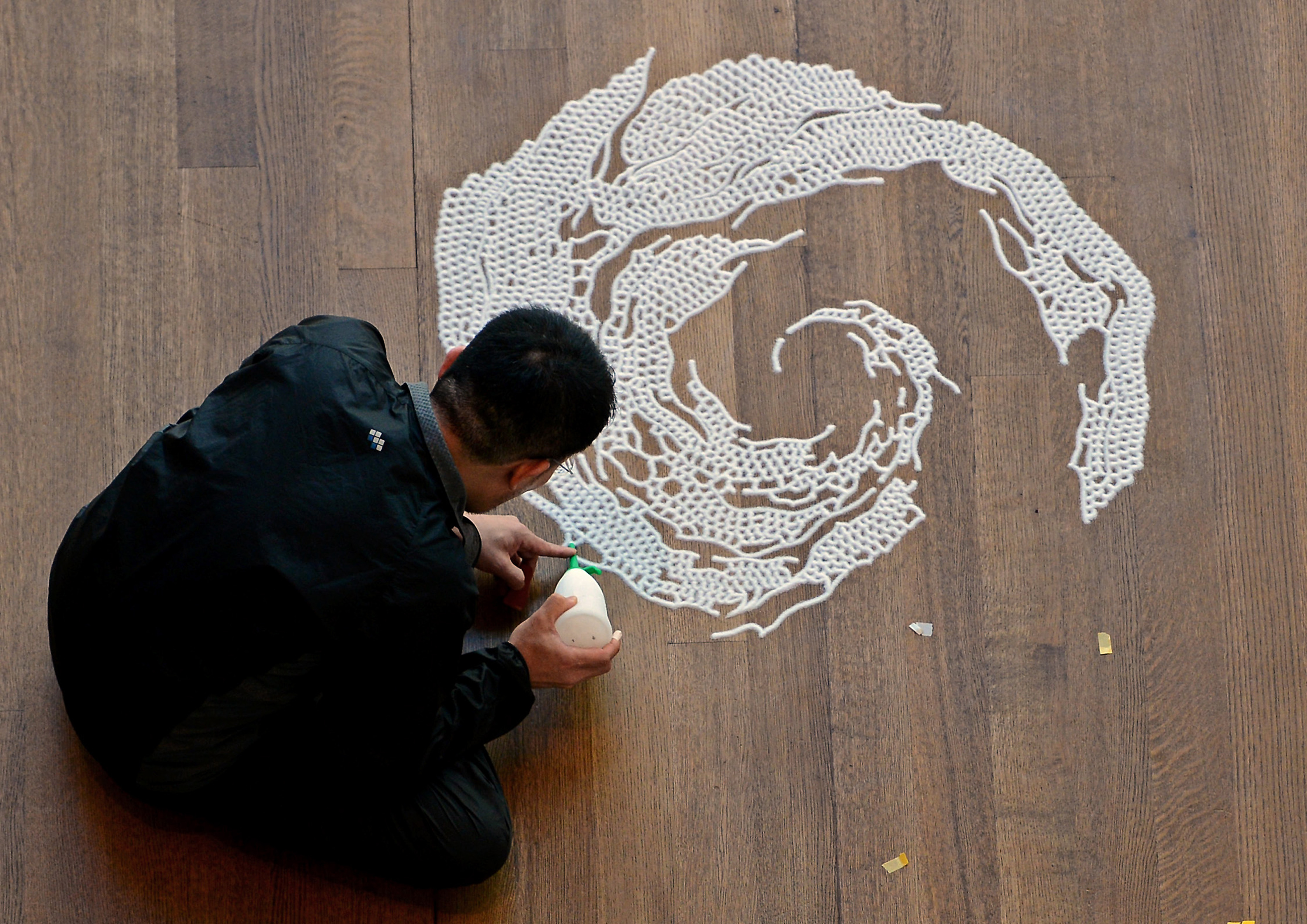 Artist Motoi Yamamoto works on his latest saltwork in the Robert Haywood Morrison Atrium at the Mint Museum Uptown in Charlotte, North Carolina, Monday, February 18, 2013. (Jeff Siner/Charlotte Observer/MCT via Getty Images)