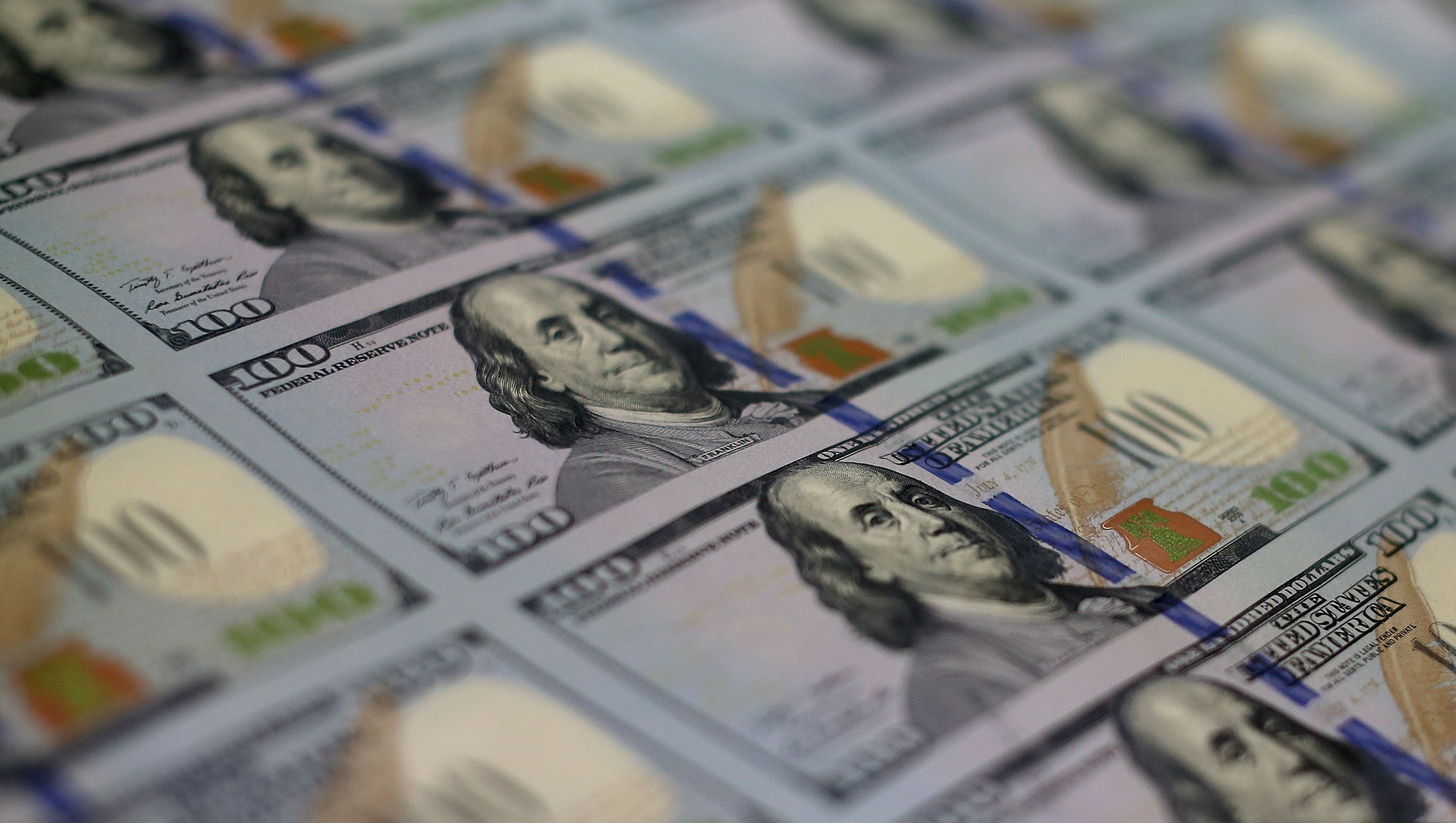 Newly redesigned $100 notes lay in stacks at the Bureau of Engraving and Printing on May 20, 2013 in Washington, DC. The one hundred dollar bills will be released this fall and has new security features, such as a duplicating portrait of Benjamin Franklin and microprinting added to make the bill more difficult to counterfeit.  (Mark Wilson/Getty Images)