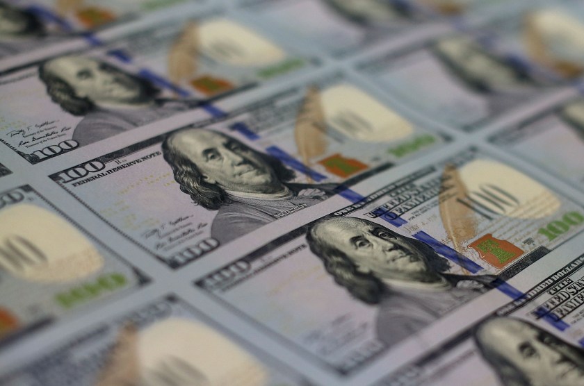 Newly redesigned $100 notes lay in stacks at the Bureau of Engraving and Printing on May 20, 2013 in Washington, DC. The one hundred dollar bills will be released this fall and has new security features, such as a duplicating portrait of Benjamin Franklin and microprinting added to make the bill more difficult to counterfeit. (Mark Wilson/Getty Images)