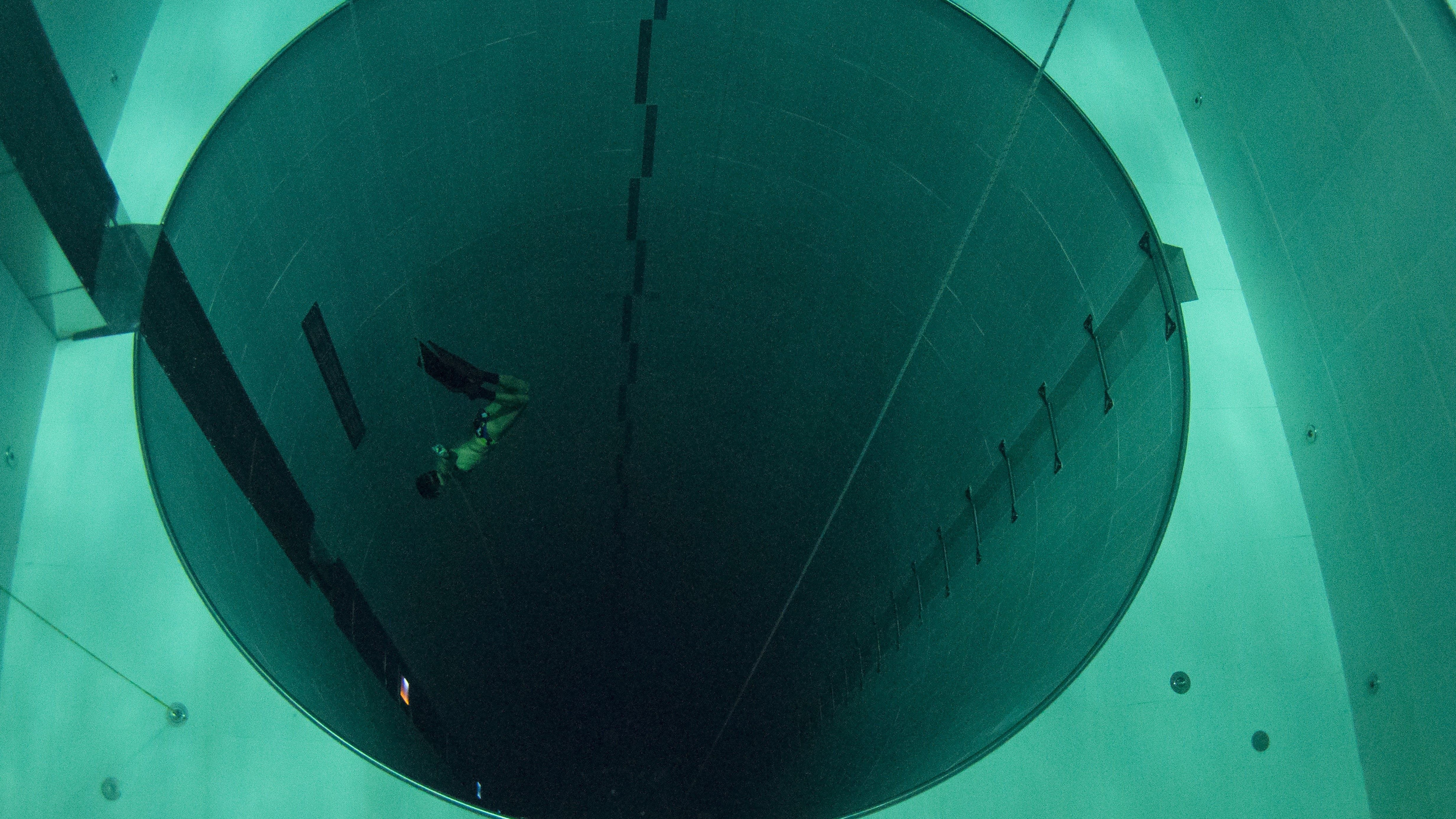 A student swims during an apnea course by Italian free diver, Umberto Pelizzari, at the "Y-40 The Deep Joy" swimming pool on December 8, 2014 in Montegrotto Terme, northeastern Italy. The swimming pool is built over thermal sources bringing after cooling down a water at 32-34 degrees Celsius. Y-40, with its depth of 42mt, is officially included in the Guinness World Record as the deepest pool in the world for free and scuba diving.  AFP PHOTO / OLIVIER MORIN        (Photo credit should read OLIVIER MORIN/AFP/Getty Images)