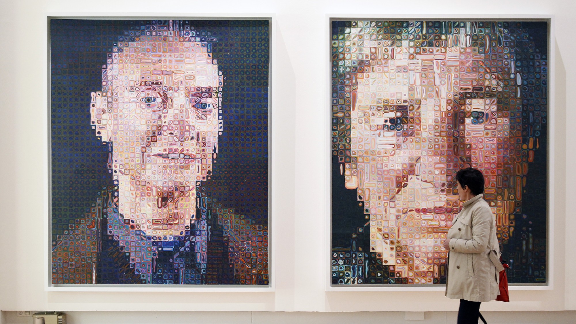 A Visitor looks at paintings by US artist Chuck Close entitled 'Roy I' and 'Agnes'during the press opening of the exhibition 'Icones Americaines' (American Icons) at the Grand Palais on April 07, 2015 in Paris, France. The exhibition runs from April 8 to June 22.  (Chesnot/Getty Images)