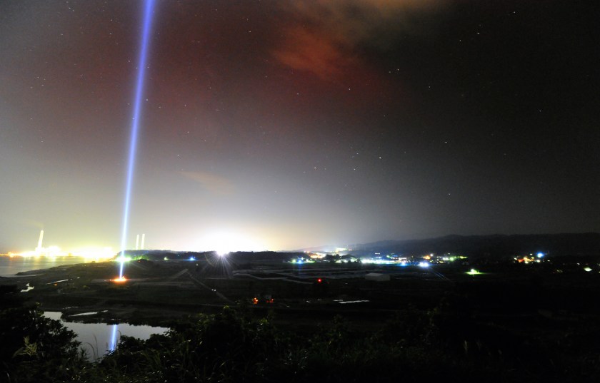 Blue tribute lights illuminate the sky as the evacuation order is to be lifted on September 4, 2015 in Naraha, Japan. (The Asahi Shimbun via Getty Images)