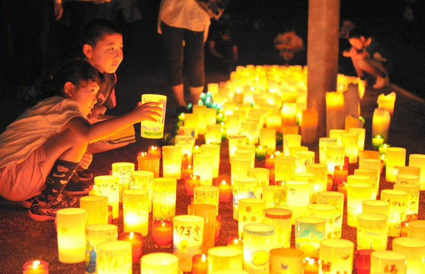 People light candles in pray for restoration as the evacuation order is to be lifted on September 4, 2015 in Naraha, Japan. (The Asahi Shimbun via Getty Images)