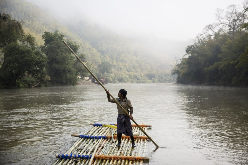 A worker controls the raft of a rig at a sand dredging site on a river near Kengtung, Shan State, Myanmar, on Thursday, Feb. 18, 2016. The recently-elected National League for Democracy has been vague about its plans for the country. Its economic platform pledged to do things such as expand the tax base and increase foreign investment, without saying how. (Taylor Weidman/Bloomberg via Getty Images)