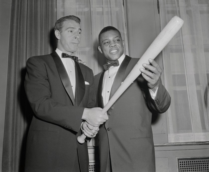 (Original Caption) Joe DiMaggio, (L) who was just voted to Baseball's Hall of Fame, passes on a few batting tips to Willie Mays, who's a slugger in his own right. Their meeting occurred at the 32nd Annual dinner of the Baseball Writers at the Waldorf Astoria tonight. Mays, Giant outfielder and last year's NL MVP, won the Scribes' Sid Mercer Award as "Player of The Year." His batting average last year was .345. He hit 41 homers and has a slugging average of .667.