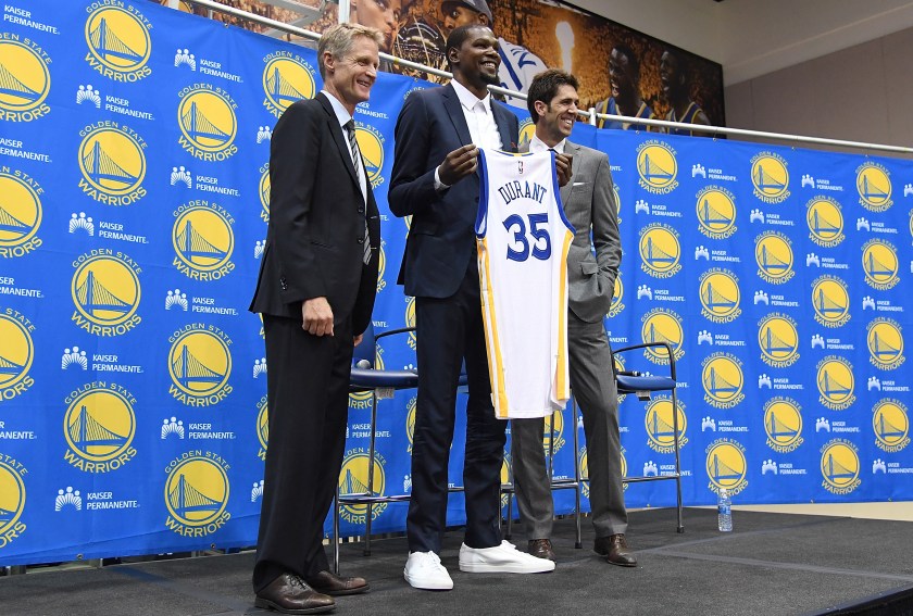 Head coach Steve Kerr of the Golden State Warriors stands with Kevin Durant #35 and general manager Bob Myers while they pose for this photo during the press conference where Durant was introduced as a Golden State Warrior after they signed him as a free agent on July 7, 2016 in Oakland, California. (Thearon W. Henderson/Getty Images)