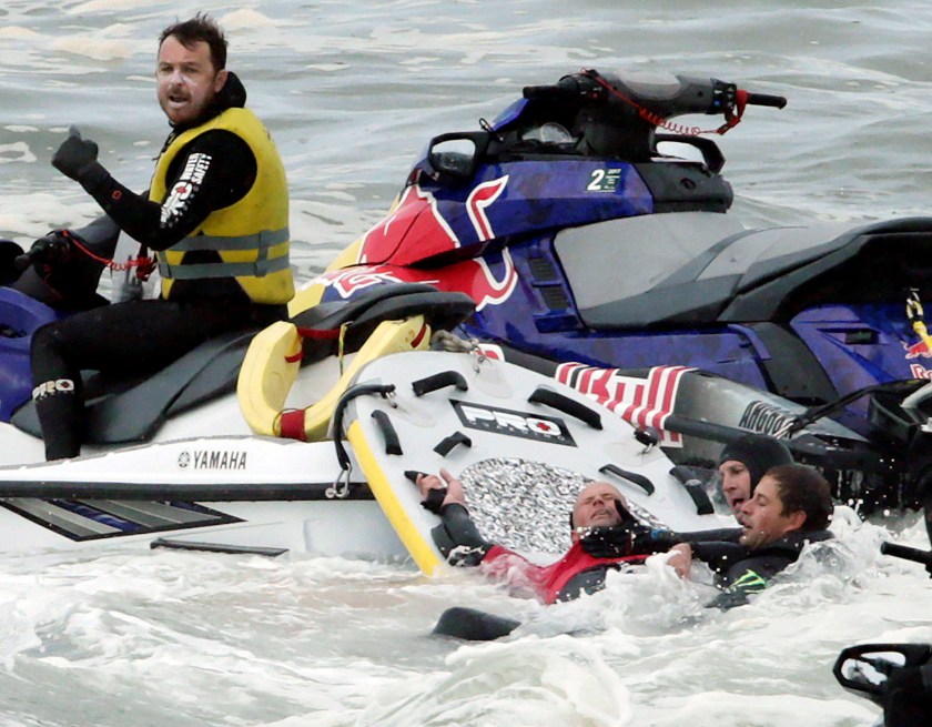 Rescue swimmers brace the neck of Australian surfer Justen Allport with their hands after he wiped out during competition at the Cape Fear surfing tournament off Sydney's Cape Solander in Australia, June 6, 2016. (Reuters/Jason Reed)
