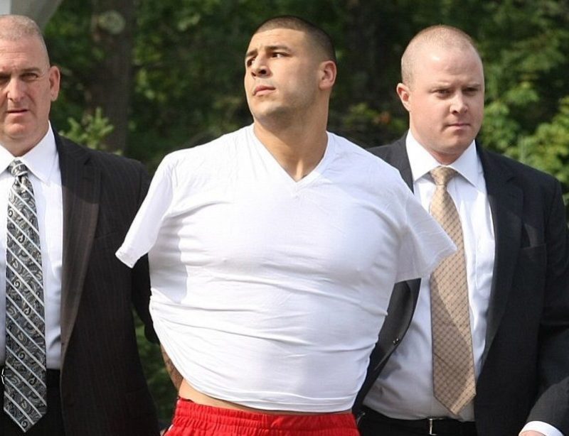 NORTH ATTLEBOROUGH, MA - JUNE 26: New England Patriots tight end Aaron Hernandez was arrested and led out of his home in handcuffs, shortly before 9 a.m. It is not immediately known what charges he is facing, but he has been under investigation in connection with the murder of Odin Lloyd. (Photo by George Rizer for The Boston Globe via Getty Images)