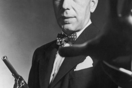 1951: American actor Humphrey Bogart carrying a gun and holding out his hand, in a still from director Bretaigne Windust's film, 'The Enforcer'. (Photo by American Stock/Getty Images)