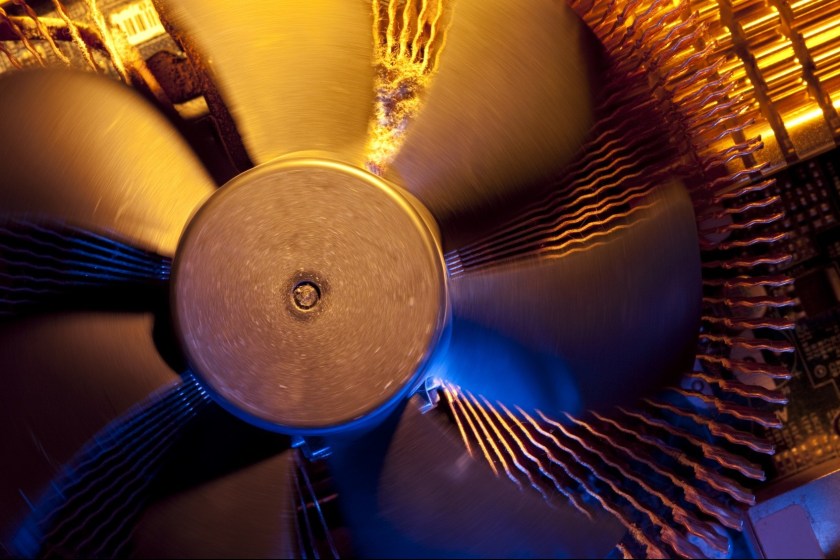 Fan and lots fluff in opened computer. Shallow depth of field