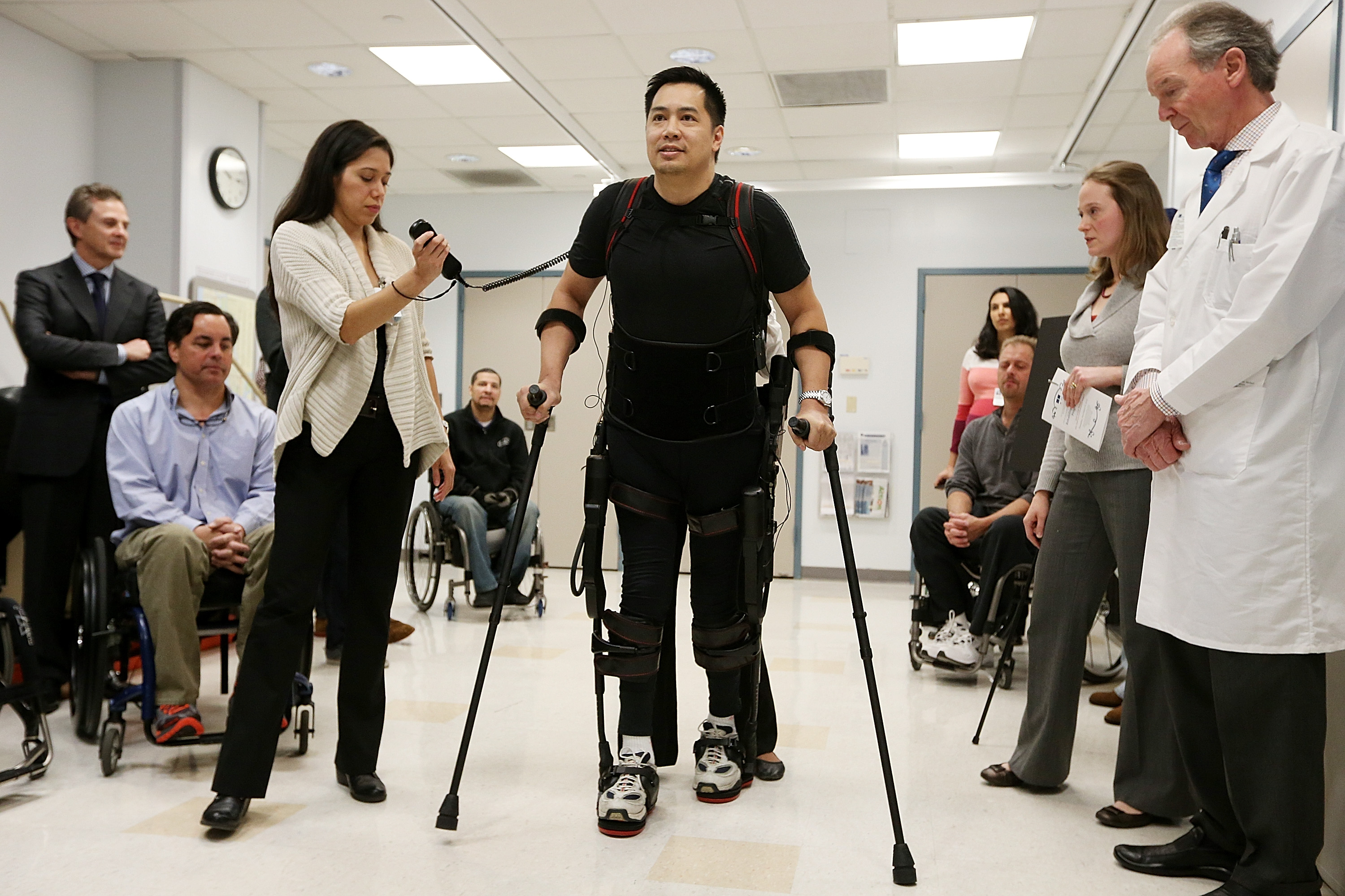 Forty three-year-old parapalegic Robert Woo walks with an exoskeleton device made by Ekso Bionics during a demonstration at the opening of the Rehabilitation Bionics Program at Mount Sinai Rehabilitation Center on December 6, 2012 in New York City. Woo is an architect who was paralyzed from the hips down during a construction accident and thought he would never walk again. The new strap-on exoskelton uses motors and sensors to physically move the legs. (Mario Tama/Getty Images)
