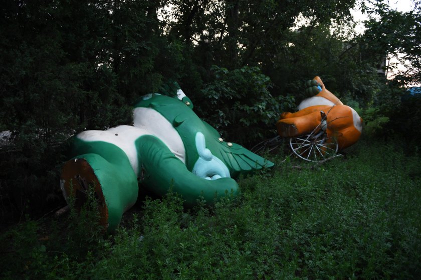 This photo taken on July 26, 2016 shows Nini (L) and Yingying, two of the five mascots for the 2008 Beijing Olympic Games, lying among trees behind an abandoned, never-completed mall in Beijing. Photographed weeks before the 2016 Olympics open in Rio, the fallen mascots are a reminder of the high costs of hosting the event. Their derelict state reflects the challenges that China has faced in finding new uses for its Olympic investments, with many venues falling into disrepair and some construction projects left incomplete. / AFP / GREG BAKER / TO GO WITH STORY Oly-2016-Rio-China-mascots-offbeat (Photo credit should read GREG BAKER/AFP/Getty Images)