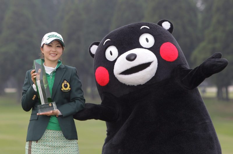 KIKUYO, JAPAN - APRIL 19: Erika Kikuchi of Japan lifts the trophy with Kumamoto prefecture's mascot Kumamon during a ceremony following the KKT Cup Vantelin Ladies Open at the Kumamoto Airport Country Club on April 19, 2015 in Kikuyo, Japan. (Photo by Chung Sung-Jun/Getty Images)