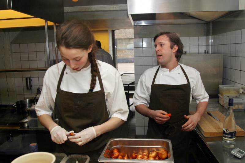 Copenhagen, DENMARK: WITH AFP STORY "NEW NORDIC CUISINE: DISHES NOT TO BE SNIFFED AT BY VIKINGS" A picture taken 02 April 2006 in the kitchen of his Copenhagen restaurant, Noma, shows chef Rene Redzepi (R) and one of his cooks preparing the evenings' meal. Think Nordic food and what comes to mind is not all that flattering -- a smorgasbord of heavy or smoked meals such as Swedish meatballs, pickled herring or a greasy joint fit for a Viking. AFP PHOTO JOE RAY (Photo credit should read JOE RAY/AFP/Getty Images)