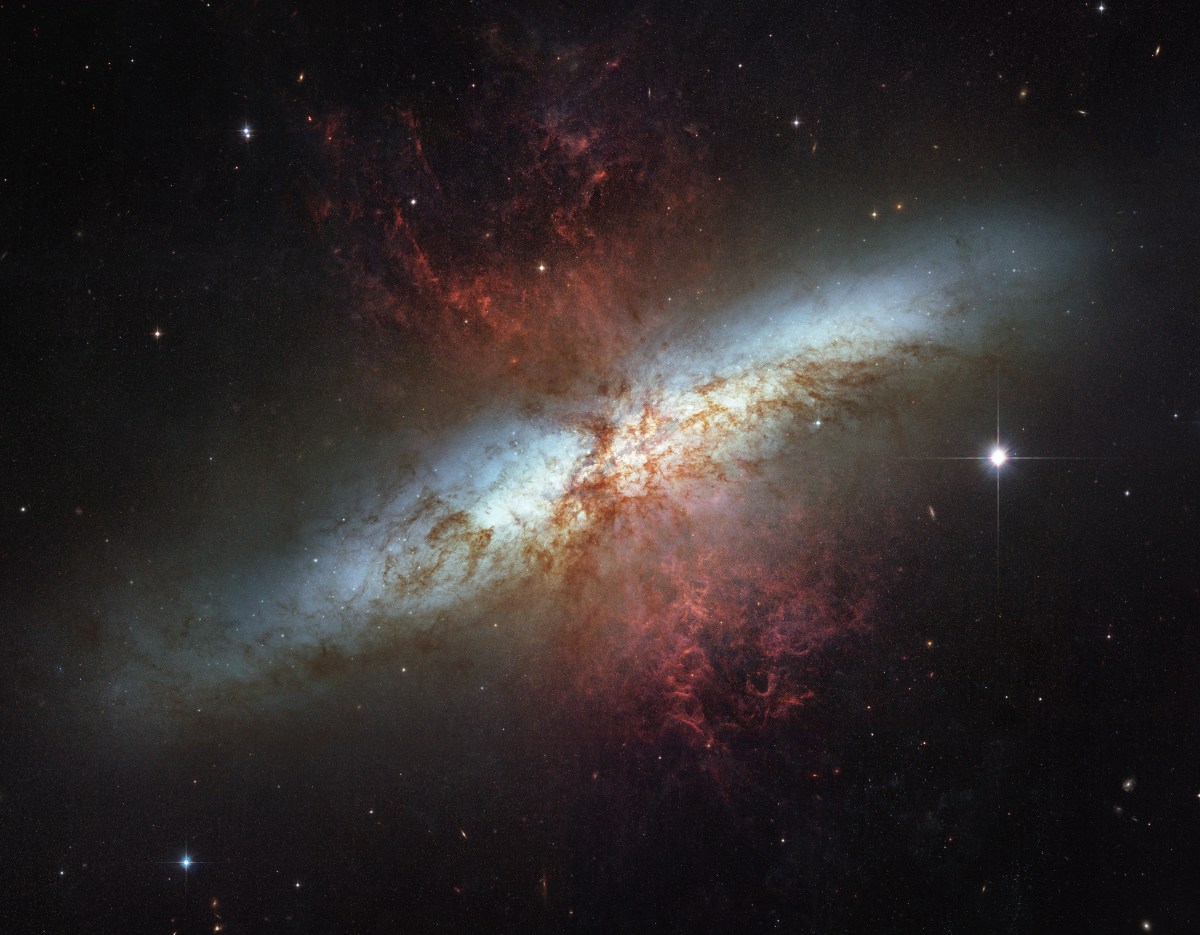 This mosaic image of the magnificent starburst galaxy, Messier 82 (M82) is the sharpest wide-angle view ever obtained of M82. It is a galaxy remarkable for its webs of shredded clouds and flame-like plumes of glowing hydrogen blasting out from its central regions where young stars are being born 10 times faster than they are inside in our Milky Way Galaxy.