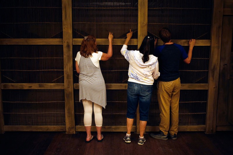 Attendees view inside a cage containing model animals in the Noah's Ark replica at the Ark Encounter theme park in Williamstown, Kentucky, U.S., on Tuesday, July 5, 2016. Ken Ham, president of Answers in Genesis of Kentucky Inc., and his group created a full-scale replica of Noah's Ark to match its description in the bible. The massive 510-foot wooden ship has cost an estimate of over $100 million to produce. Photographer: Luke Sharrett/Bloomberg via Getty Images