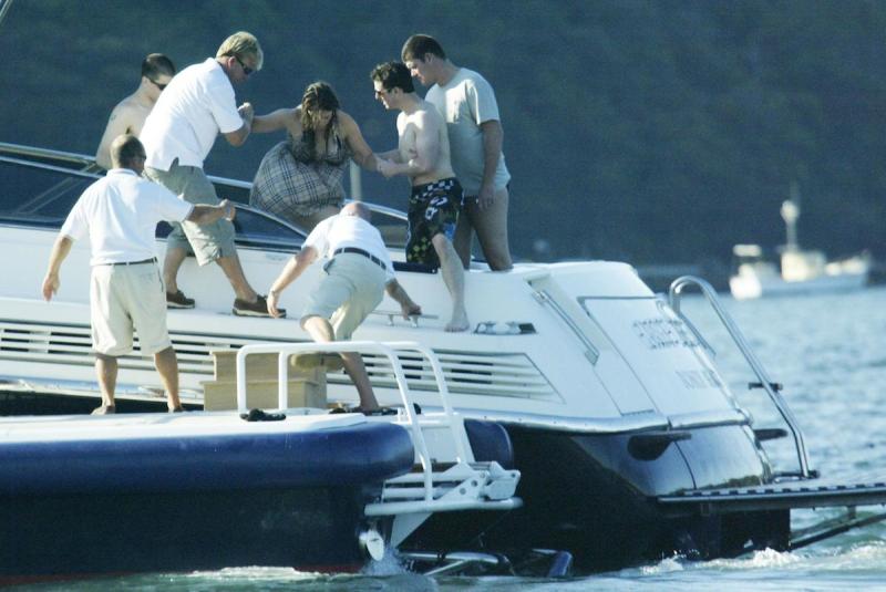 (AUSTRALIA & NEW ZEALAND OUT) Tom Cruise and James Packer help Cruise's pregnant girlfriend Katie Holmes aboard Packer's yacht Arctic P on Sydney Harbour, 18 February 2006. SHD Picture by ANDREW MEARES (Photo by Fairfax Media via Getty Images)