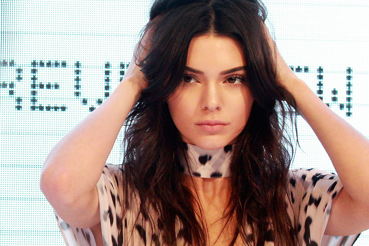 Kendall Jenner adjusts her hair on stage at Westfield Parramatta on November 17, 2015 in Sydney, Australia.  (Photo by Lisa Maree Williams/Getty Images)