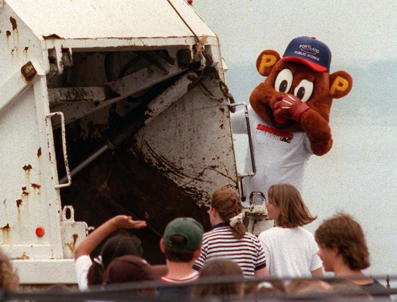 STAFF PHOTO BY GORDON CHIBROSKI -- Monday, July 28, 1997 -- Portland school kids rejoice as a load of cigarette paraphenalia is trashed by Portland PUblic Works mascot at Fort Allen Park, site of a Portland Public Health Division and Cancer Society rally to keep kids from starting smoking. Kids traded cigarette related items from Marlboro Computer CD-ROMs, key chains, pens, hats and t-shirts with cigarette advertising for t-shirts with the message,"Smoking. It's a Drag!" (Photo by Gordon Chibroski/Portland Press Herald via Getty Images)