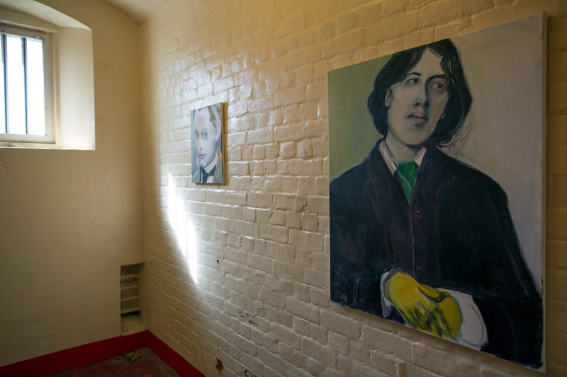 READING, ENGLAND - SEPTEMBER 01: A picture of Oscar Wilde hangs inside a cell inside the former Reading prison building on September 1, 2016 in Reading, England. The former Reading Prison has opened to the public for the first time, inviting artists and writers in to take part in a new project by Artangel, with works by leading artists including Marlene Dumas, Robert Gober, Nan Goldin, Steve McQueen, and Ai Weiwei. The exhibition opens to the public from September 4, 2016. Included in the exhibit is former inmate Oscar Wildes original wooden cell door, which is on display in the prison chapel. (Photo by Dan Kitwood/Getty Images)