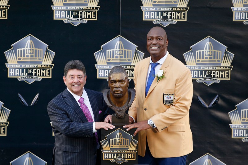 CANTON, OH - AUGUST 8: Charles Haley poses with his bust with presenter Edward DeBartolo Jr. during the NFL Hall of Fame induction ceremony at Tom Benson Hall of Fame Stadium on August 8, 2015 in Canton, Ohio. (Photo by Joe Robbins/Getty Images)