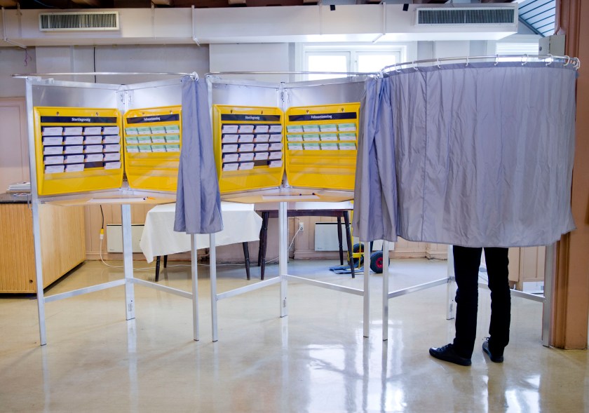 A man stands inside a polling booth in Norway. (Daniel Sannum Lauten/AFP/Getty Images)
