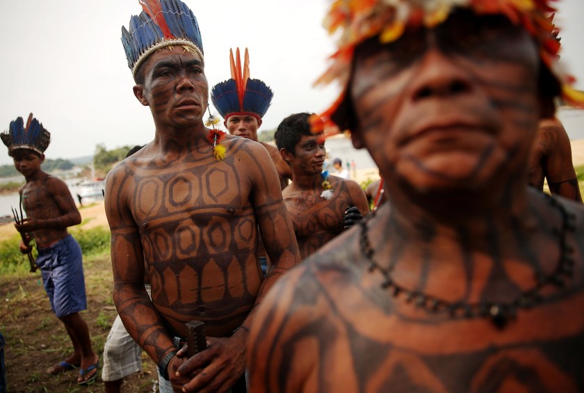 Members of the Munduruku indigenous tribe gather along the Tapajos River during a "Caravan of Resistance'" protest by indigenous groups and supporters who oppose plans to construct a hydroelectric dam on the Tapajos River in the Amazon rainforest on November 27, 2014 in Sao Luiz do Tapajos, Para State, Brazil. (Mario Tama/Getty Images)