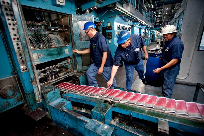 Phomma Phanthorath, right, Bobby Lake, center, and Gary Hoyen check copies of AH Belo Corp.'s Dallas Morning News for print errors at a printing press in Plano, Texas, U.S., on Thursday, Dec., 17, 2009. U.S. newspaper publishers' revenue dropped 8.3 percent to $43.9 billion last year as advertising sales plunged, the U.S. Census Bureau said yesterday. (Matt Nager/Bloomberg via Getty Images)