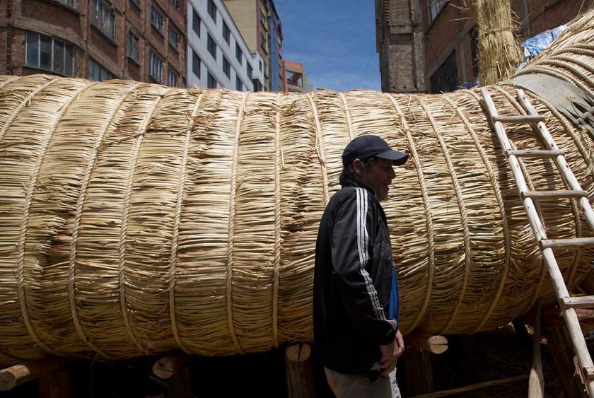 American explorer Phil Buck walks past the reed boat built by Bolivian Aymara Indians, in La Paz, Bolivia, Wednesday, Oct. 19, 2016. (Juan Karita/AP)