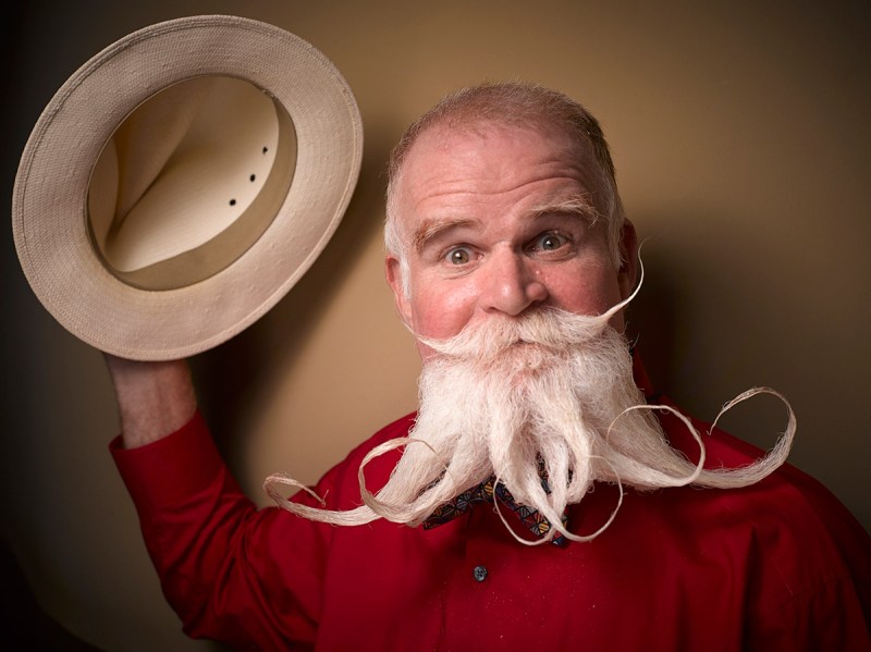 PIC BY GREG ANDERSON / CATERS NEWS - (PICTURED: A contestant of the beard championship with a curly beard.) - Gents from around the world descended on Nashville earlier this month fighting for the title of best beard in the National Beard and Moustache Championship. The annual competition covers 17 categories in which the men can compete, ranging from freestyle, to natural, to facial hair inspired by icons such as Dali and the Musketeers. With the competition as stiff as the waxed moustaches, competitors had to go beard to beard to decide whose facial fuzz was the most fan-TASH-tic. Competitors were judged on their overall appearance, style and personality, with judges also considering originality and creativity in the freestyle categories. Contestants certainly rose to the challenge with perfectly curled beards and also more outrageous statement styles, such as a Tim Burton themed beard, and a beard styled to look like a beak. - SEE CATERS COPY