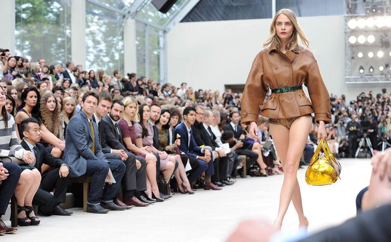 LONDON, ENGLAND - SEPTEMBER 17: Julian Ovenden, Pete Reed, Saif Ali Khan, Alice Eve, Victoria Pendleton, Aaron Paul, Dita Von Teese, Harry Styles, Dev Patel, Gabriella Wilde, Mario Testino, Harvey Weinstein and Sir Jonathan Ive watch from the front row as model Cara Delevingne walks the runway during the Burberry Spring Summer 2013 Womenswear Show at Kensington Gardens on September 17, 2012 in London, England. (Photo by Dave M. Benett/Getty Images for Burberry)