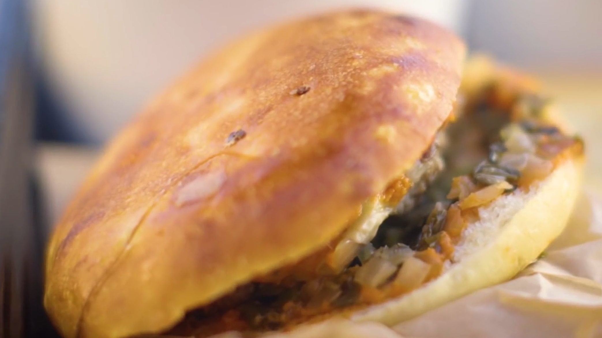 Locol's 'cheeseburg,' a healthy cheeseburger alternative with a patty comprised of 30% cooked grains and tofu, inside a Koji-leavened bun (Screengrab)