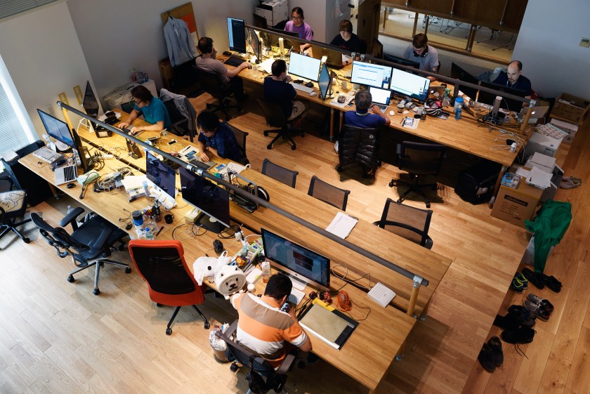 Employees of startup companies that got financial backing from Mistletoe Inc. work in front of computer screens at the Mistletoe Base Camp Tokyo office, in Tokyo, Japan, on Tuesday, Aug. 30, 2016. When he launched Mistletoe three years ago, Taizo Son, chief executive officer, sought to emulate Silicon Valley venture firm Andreessen Horowitz's ability to draw on the knowledge of a network of experts, as well as Google's backing of long-term projects. (Akio Kon/Bloomberg via Getty Images)