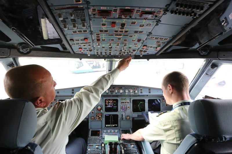 Pilots operate flight control systems in the cockpit of an Airbus A319 passenger jet operated by S7 at Domededovo airport in Moscow, Russia, on Wednesday, Oct. 26, 2016. S7, also known as Siberian Airlines, will become first Russian airline to get new Boeing Co. jets in Sept. 2018, Vedomosti reported. Photographer: Andrey Rudakov/Bloomberg