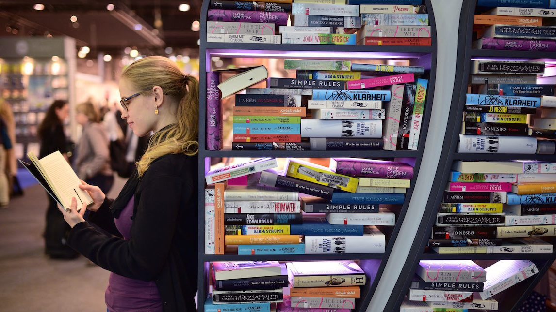 FRANKFURT AM MAIN, GERMANY - OCTOBER 15:  A woman reads a book at the 2015 Frankfurt Book Fair (Frankfurter Buchmesse) on October 15, 2015 in Frankfurt am Main, Germany. The 2015 fair, which is among the world's largest book fairs, will be open to the public from October 13-18.  (Photo by Thomas Lohnes/Getty Images)