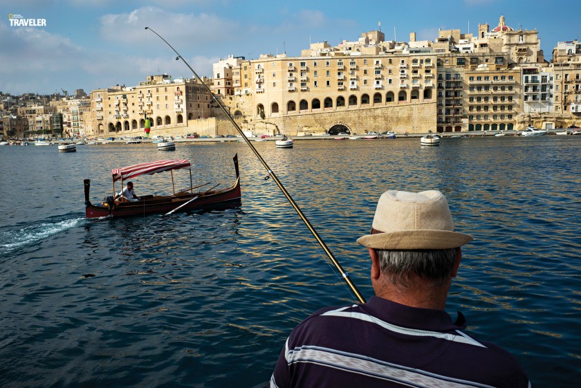 An angler tries his luck in one of Valletta’s many inlets fronted by honey-hued stone buildings. (Courtesy National Geographic Traveler)