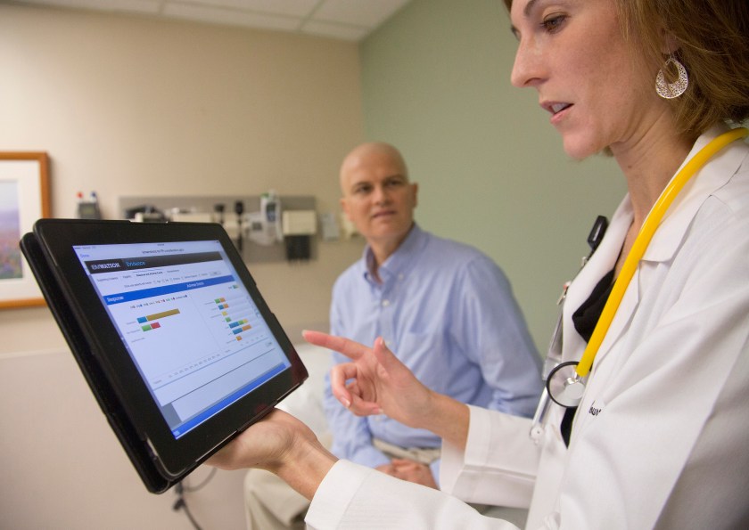 At the University of Texas MD Anderson Cancer Center, Assistant Professor of Leukemia Dr. Courtney DiNardo uses IBM's Watson cognitive system while consulting with patient Rich Ware, on October 18, 2013. Starting with the fight against Leukemia, IBM's Watson will help MD Anderson physicians develop, observe and fine tune cancer treatment plans, match patients with clinical trials and recognize adverse effects during ongoing care. (IBM Watson Health)