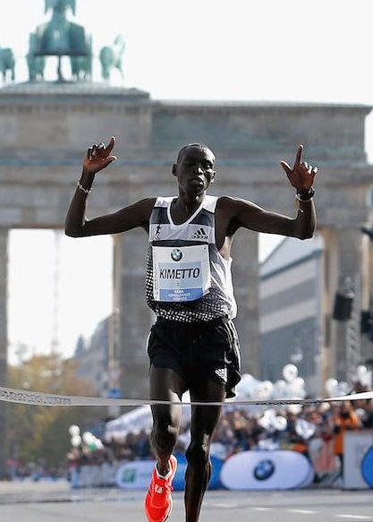 BERLIN, GERMANY - SEPTEMBER 28:  Dennis Kimetto of Kenya crosses the finish line in new world record time during the 41th BMW Berlin Marathon on September 28, 2014 in Berlin, Germany.  (Photo by Boris Streubel/Bongarts/Getty Images)