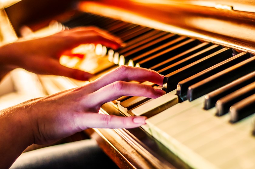 A person's hands are shown in the midst of playing the piano (Getty Images)