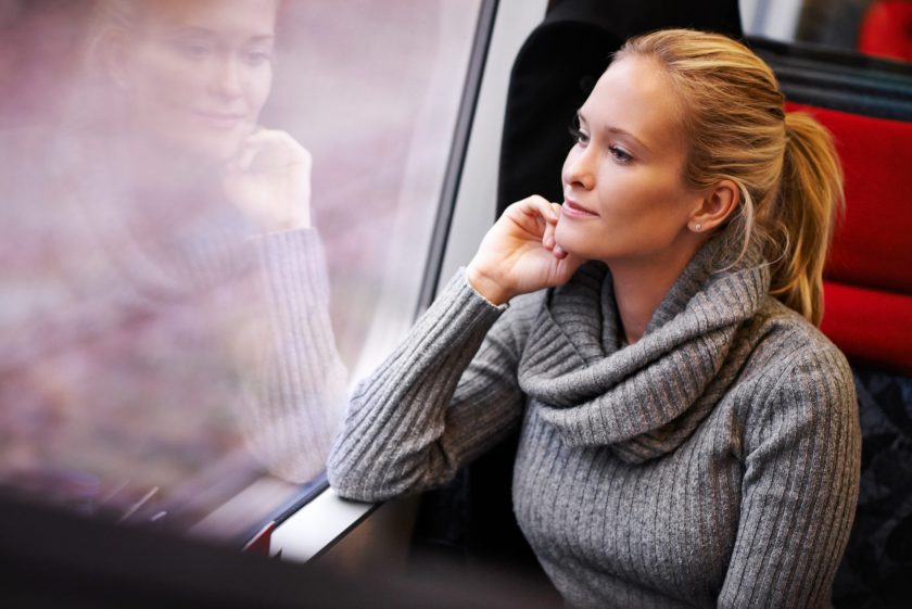 Cropped shot of an attractive young woman traveling by train