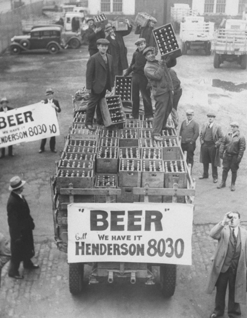 Men atop beer delivery truck hoist cases of beer triumphantly while man standing in front of truck drinks out of beer bottle following the repeal of Prohibition. (Time Life Pictures/National Archives/The LIFE Picture Collection/Getty Images)